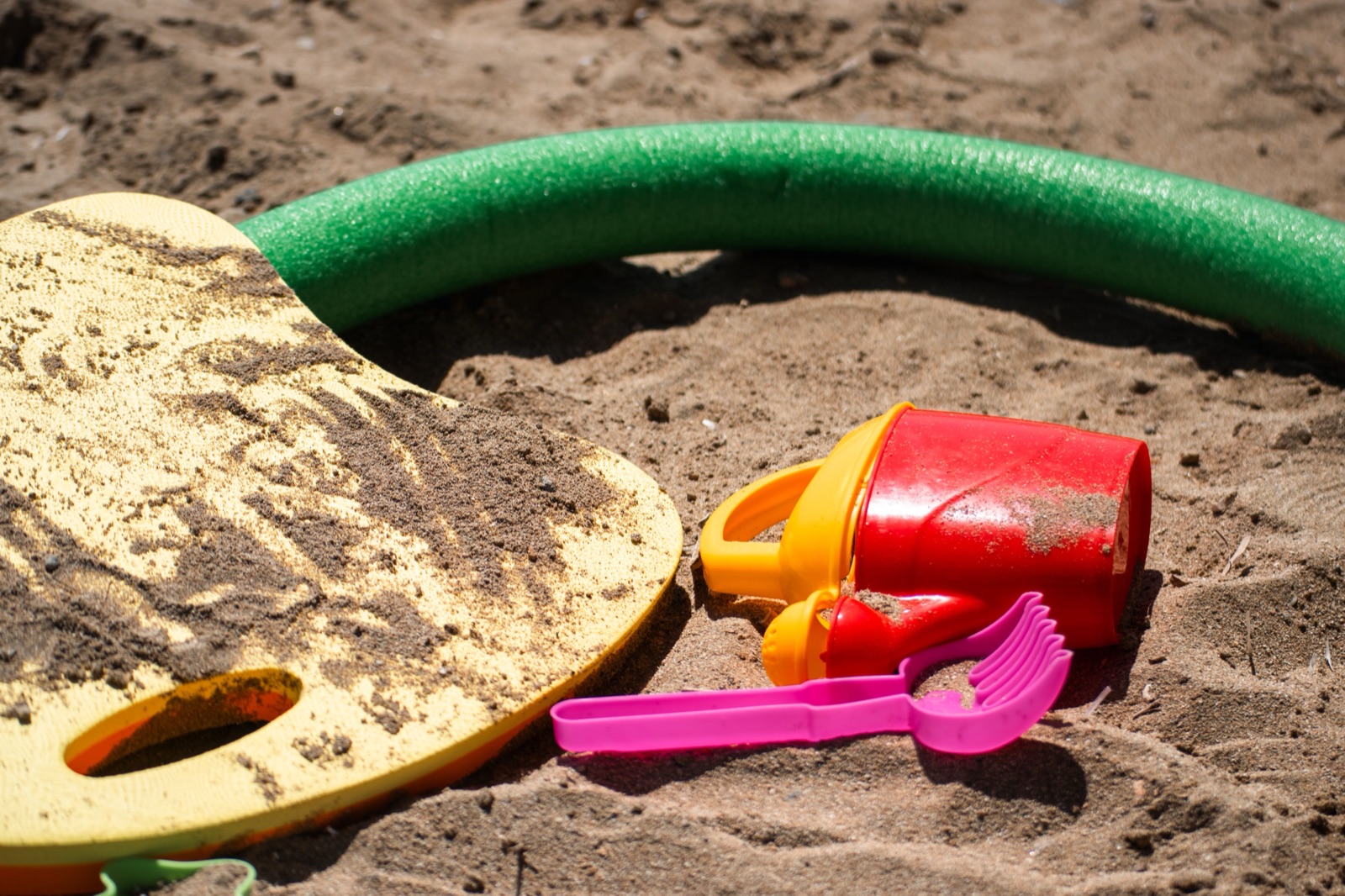 Speelgoed in het zand met een schep en emmer
